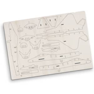 A wooden model kit of a jet fighter, featuring various pre-cut pieces on a light wood board, with a logo present.