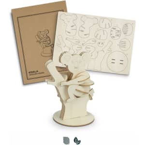 A koala wooden model kit in natural wood with cut-out pieces and packaging featuring koala designs.