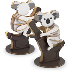 Two wooden koala models in white, grey, and brown, perched on a tree branch, showcasing a playful design.