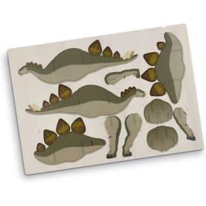 A wooden model kit featuring a green Stegosaurus shape with brown accents, including its iconic plates and tail.