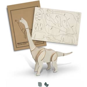 A wooden model of a Brachiosaurus in natural wood colour, alongside its cardboard packaging and assembly pieces.