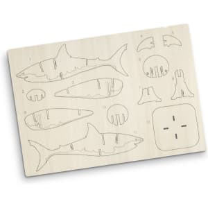 A plywood model kit featuring shark pieces, outlined for assembly, in natural wood colour. Includes a branding logo.