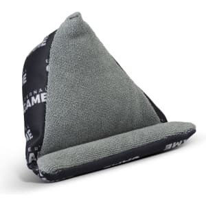 A grey and black bean bag phone holder with a textured surface and a triangular shape, featuring a logo design.