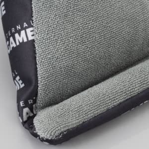 A green and black bean bag phone holder with a textured surface and a branding logo.