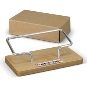 A bamboo business card stand with a silver metal frame, packaged in a brown cardboard box, featuring a logo.