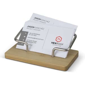 A bamboo business card stand with a silver metal holder, displaying several business cards in a neat arrangement.