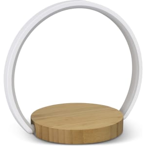 A wireless charging night light featuring a circular white frame and a round bamboo base.