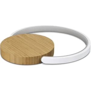 A round wireless charging pad with a bamboo top and a white base, featuring a minimalist design.