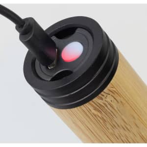 A bamboo torch with a charging port, featuring a red indicator light, set against a plain background.