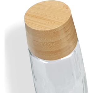A drink bottle featuring a clear glass body and a bamboo lid, designed for practical use.