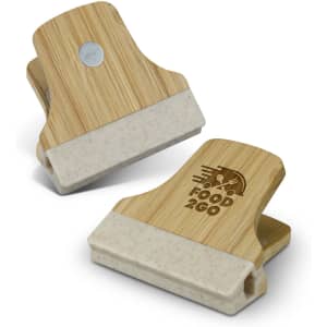 A bamboo clip with a beige section at the bottom, featuring a logo on one side.