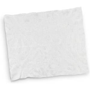 A small, compressed white towel with a textured surface, featuring a logo.
