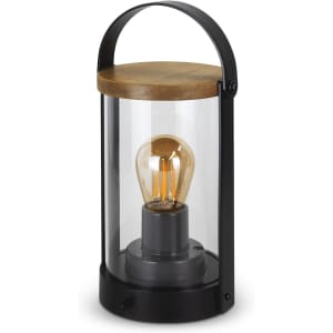 A black lantern with a glass body and wooden top, featuring a vintage-style bulb inside.