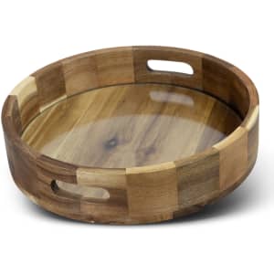 A round wooden platter tray with a smooth surface and cut-out handles, featuring a mix of light and dark wood tones.