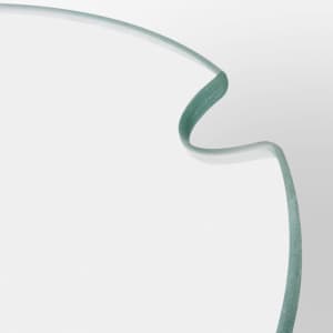 A transparent glass keepsake platter tray with a softly curved edge, featuring a subtle green tint.