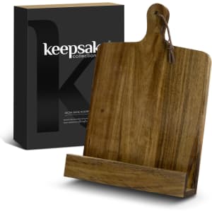 A wooden recipe book holder in a natural finish, presented with a sleek black packaging box featuring a logo.