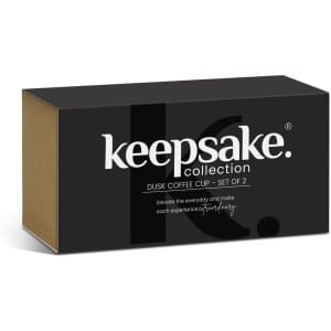 A set of two coffee mugs in a sleek black box, featuring the Keepsake logo. The mugs are designed for elegant drinkware.