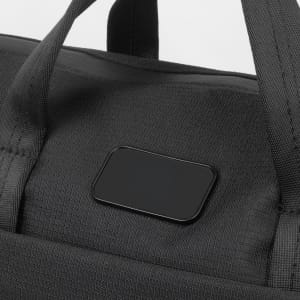 A black computer bag with sturdy handles and a branding logo on the front.