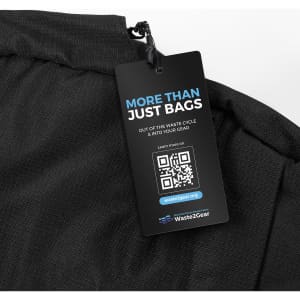 A black computer bag with a textured surface and a promotional tag attached. The tag has a QR code and branding.