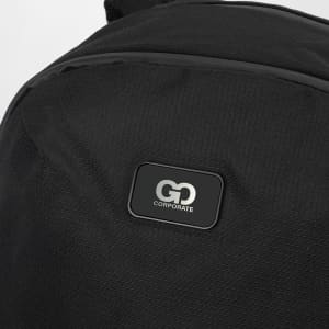 A black computer backpack featuring a textured fabric and a logo patch on the front.