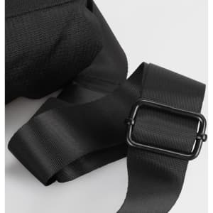 A black sling bag featuring sturdy straps and a metal buckle, showcasing a textured fabric.