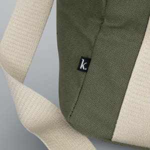 A green cooler bag features a light fabric strap and a small logo tag on the side.