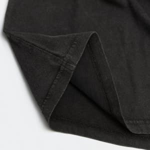 A faded black unisex T-shirt featuring a simple design and a subtle logo on the fabric.