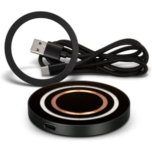 A black wireless charger with circular design and a USB charging cable in a coiled arrangement.