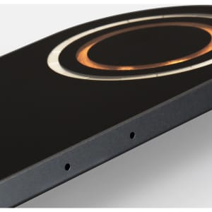 A dual wireless charger in black with a circular design and a metallic accent, featuring a logo.
