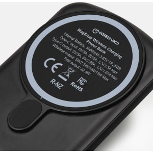 A black wireless charging power bank with a circular charging pad and a logo on the surface.