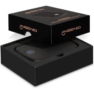 A black wireless charging power bank in an open box, featuring a logo and sleek design.