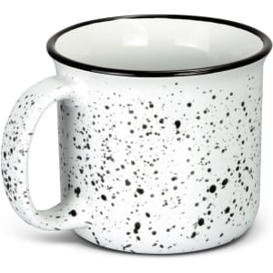 A ceramic mug in white with a speckled black pattern and a black rim, featuring a handle and a logo.