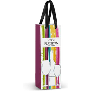 A full-colour paper bag in shades of pink, green, and yellow, with a black ribbon handle and a logo.