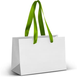 A white paper bag with green ribbon handles, featuring an unmarked surface and a sturdy rectangular shape.