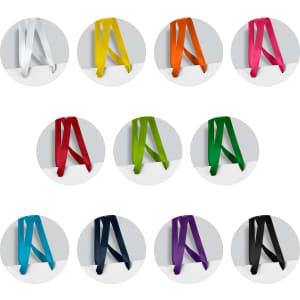 A selection of small ribbon handle paper bags in various colours, including white, yellow, orange, pink, green, black, navy, and purple, with branding.