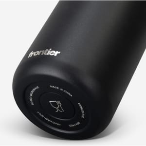 A drink bottle in matte black with a silver logo, featuring a curved shape and a base design.