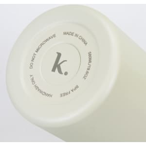 A drink bottle in a soft cream colour with a round base featuring a logo and care instructions.