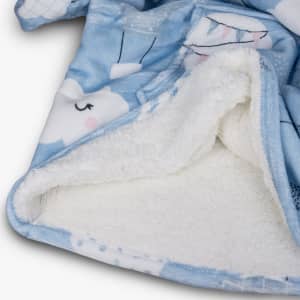 A fluffy hoodie blanket in blue featuring cloud and pattern designs, with a soft, white interior lining.