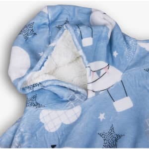 A blue blanket hoodie with a fluffy lining, featuring a design of clouds and stars. It includes a large hood.