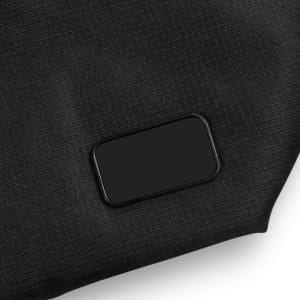 A black cooler made from textured material, featuring a rectangular logo or branding area.