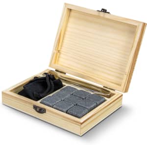 A wooden gift box containing grey whiskey stones, a black pouch, and a stainless steel tongs.