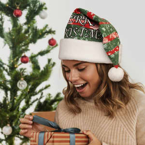 A woman wearing a full colour green and white Santa hat, surprised while opening a gift, with a Christmas tree in the background.