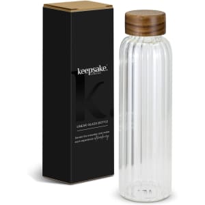 A drink bottle made of clear glass with a ribbed design and a wooden lid, packaged in a black box with branding.