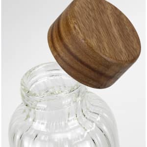 A drink bottle with a clear glass body and a wooden lid, featuring a simple, elegant design.