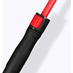 A close-up of a black and red handle of a Monsoon Umbrella, featuring a textured grip and a branding logo.