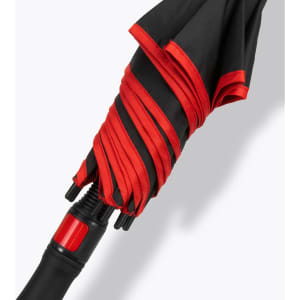 A black and red umbrella with a folded canopy and a black handle featuring a branding logo.