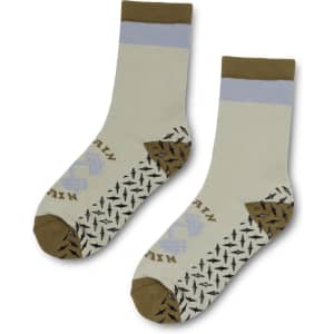 A pair of crew grip socks in light green, brown, and grey featuring a patterned sole and a logo.