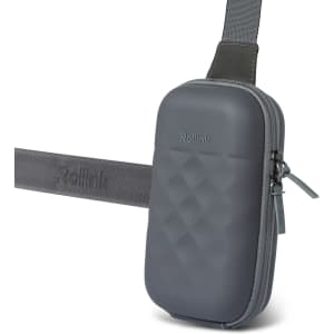 A grey Rollink Mini Bag Go featuring a textured surface and an adjustable strap. It includes a zip closure and logo branding.