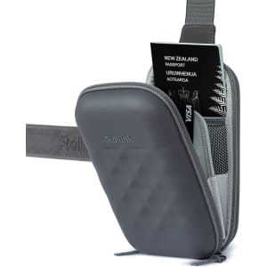 A grey Rollink Mini Bag Go with a passport and card visible inside, featuring a textured surface and a shoulder strap.