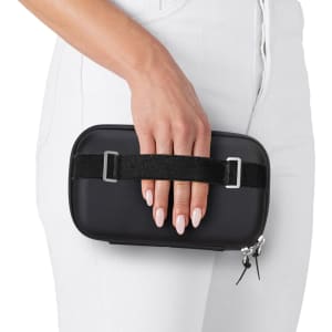 A black Rollink Mini Bag Tour held in hand, featuring a sleek design and a fabric strap.